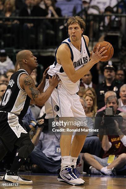 Forward Dirk Nowitzki of the Dallas Mavericks and Keith Bogans of the San Antonio Spurs in Game One of the Western Conference Quarterfinals during...