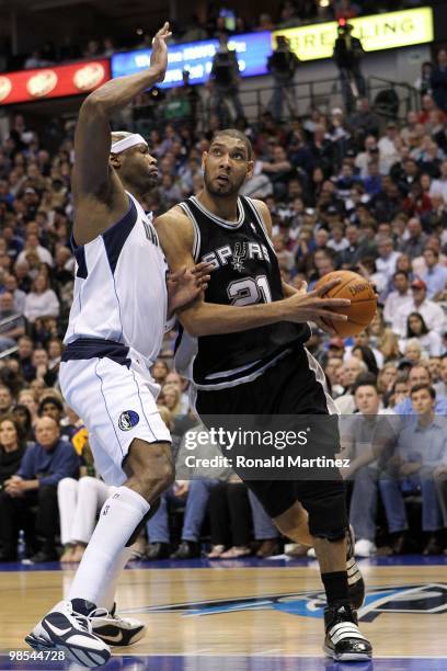 Forward Tim Duncan of the San Antonio Spurs dribbles the ball against Erick Dampier of the Dallas Mavericks in Game One of the Western Conference...