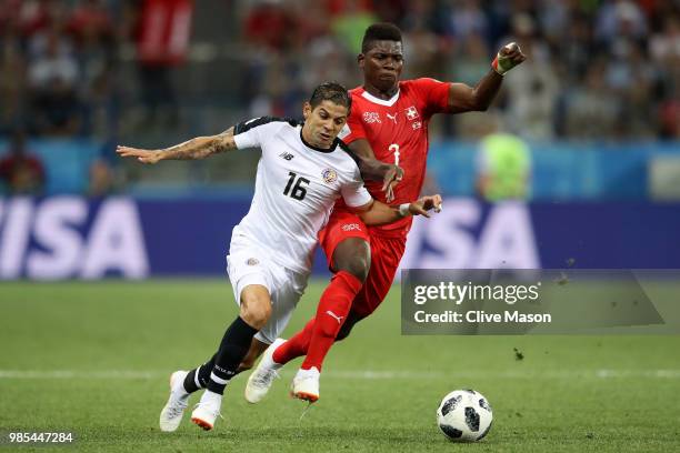 Cristian Gamboa of Costa Rica is challenged by Breel Embolo of Switzerland during the 2018 FIFA World Cup Russia group E match between Switzerland...