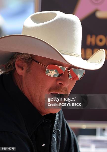 Country music performer Alan Jackson poses at his star at the unveiling ceremony on the Hollywood Walk of Fame April 16, 2010 in the Hollywood...