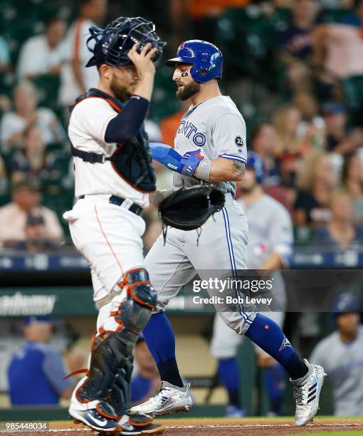 Kevin Pillar of the Toronto Blue Jays scores in the first inning in front of Max Stassi of the Houston Astros at Minute Maid Park on June 27, 2018 in...