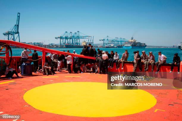 Young migrants wait on board the "Guardamar Luz de Mar" Spanish rescue ship upon their arrival at Algeciras' harbour on June 27, 2018 after being...