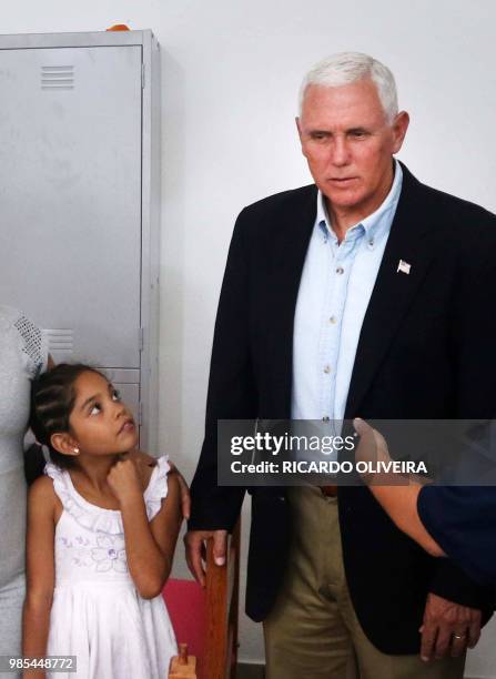 Venezuelan refugee girl looks at US Vice President Mike Pence during his visit to the Santa Catarina Humanitarian Centre in Manaus, northern Brazil,...