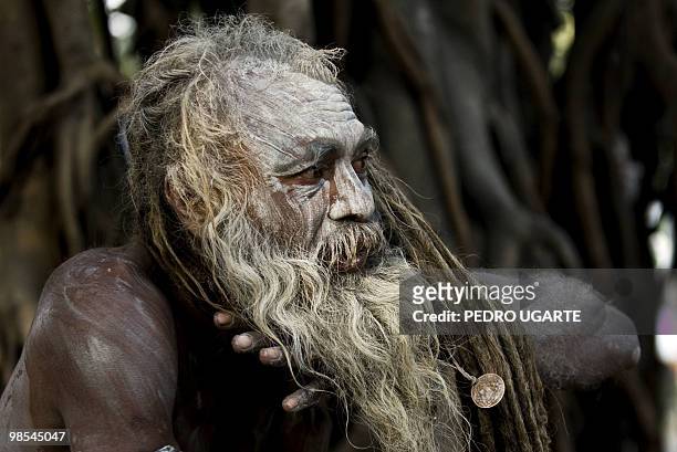 Hindu holy man applies mud on his body on the banks of river Ganges during the Kumbh Mela festival in Haridwar on April 13, 2010.The Kumbh Mela,...