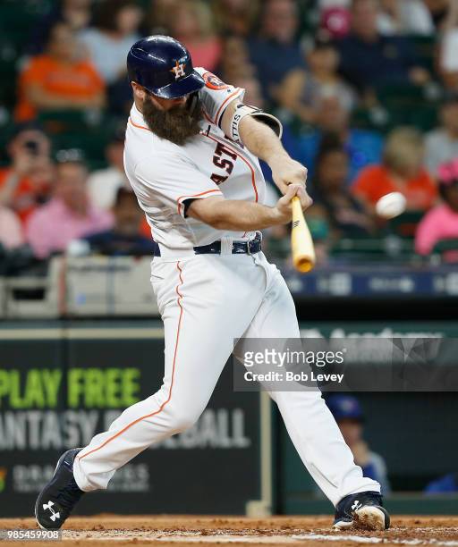 Evan Gattis of the Houston Astros doubles in two runs in the first inning against the Toronto Blue Jays at Minute Maid Park on June 27, 2018 in...