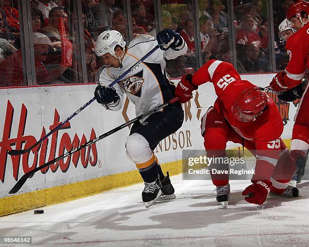 Jordin Tootoo of the Nashville Predators battles along the boards with Niklas Kronwall of the Detroit Red Wings during an NHL game at Joe Louis Arena...