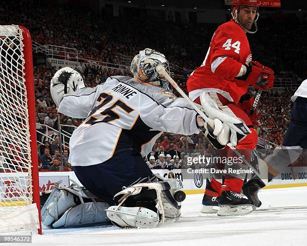Goaltender Pekka Rinne of the Nashville Predators makes a save as Todd Bertuzzi of the Detroit Red Wings set up a screen during an NHL game at Joe...