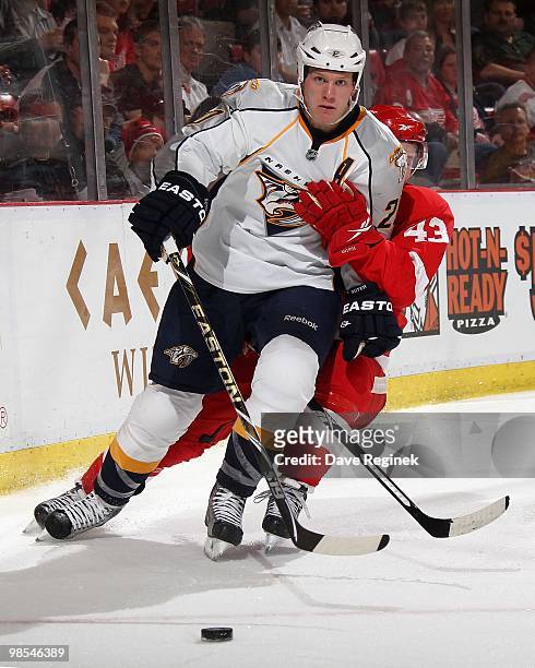 Ryan Suter of the Nashville Predators protects the puck from Darren Helm of the Detroit Red Wings during an NHL game at Joe Louis Arena on April 3,...