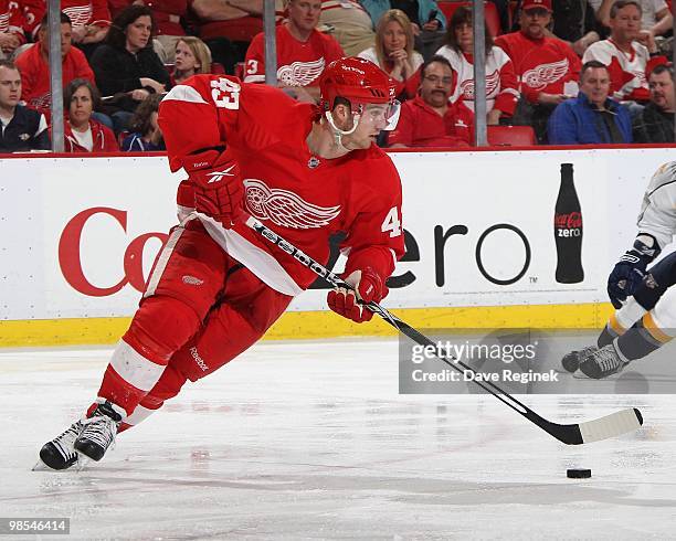 Darren Helm of the Detroit Red Wings turns with the puck during an NHL game against the Nashville Predators at Joe Louis Arena on April 3, 2010 in...