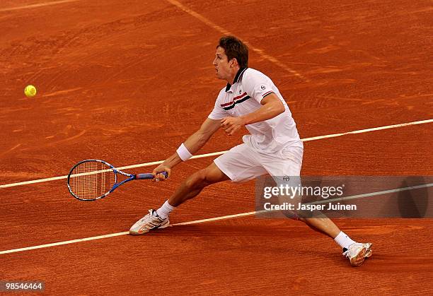 Igor Andreev of Russia slides to return a backhand to Richard Gasquet of France on day one of the ATP 500 World Tour Barcelona Open Banco Sabadell...