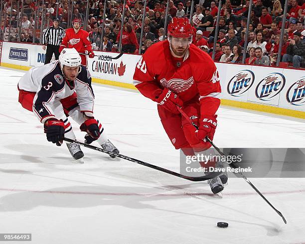 Henrik Zetterberg of the Detroit Red Wings skates around the defense of Marc Methot of the Columbus Blue Jackets during an NHL game at Joe Louis...