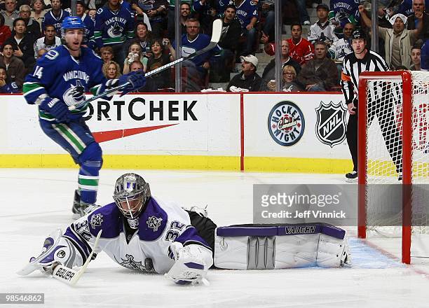 Alex Burrows of the Vancouver Canucks looks on as Jonathan Quick of the Los Angeles Kings makes a chest save in Game One of the Western Conference...
