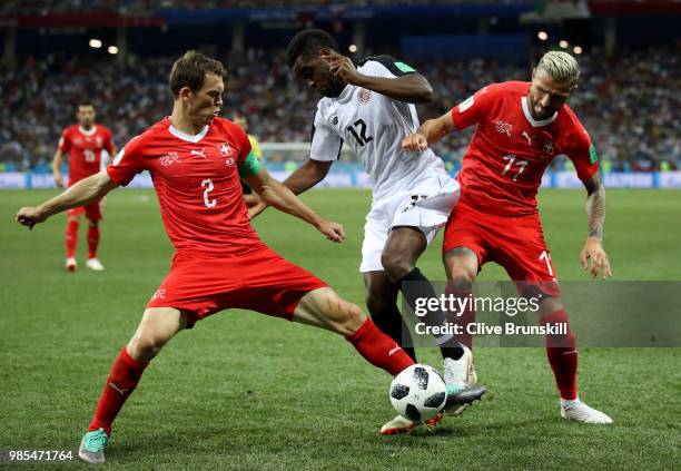Stephan Lichtsteiner of Switzerland tackles Joel Campbell of Costa Rica, whilst Valon Behrami of Switzerland also challenges him during the 2018 FIFA...