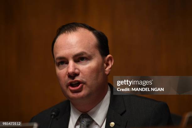 Sen. Mike Lee asks a question as T-Mobile CEO John Legere and Sprint Executive Chairman Marcelo Claure testify at the Senate Judiciary Committee's...