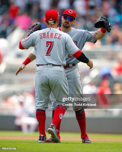 Eugenio Suarez of the Cincinnati Reds hugs Adam Duvall at the conclusion of an MLB game against the Atlanta Braves at SunTrust Park on June 27, 2018...