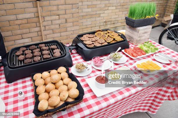 Burgers are served during the DSW Block Party hosted by Olympians Adam Rippon and Mirai Nagasu on June 27, 2018 at Ramscale Studio in New York City.