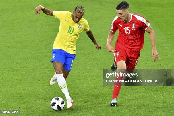 Brazil's forward Neymar challenges Serbia's defender Nikola Milenkovic during the Russia 2018 World Cup Group E football match between Serbia and...