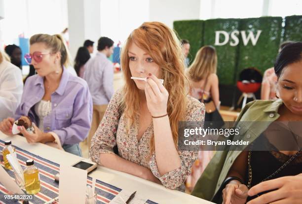 Guest enjoys the Create Your Own Scent station during the DSW Block Party hosted by Olympians Adam Rippon and Mirai Nagasu on June 27, 2018 at...