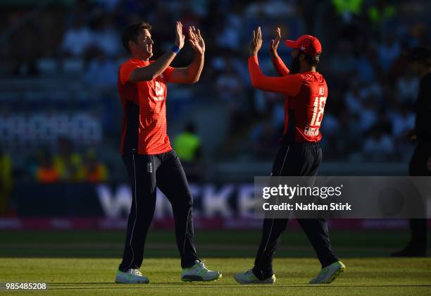 Liam Plunkett of England celebrates with Moeen Ali as he gets D'Arcy Short of Australia out during the 1st Vitality International T20 match between...