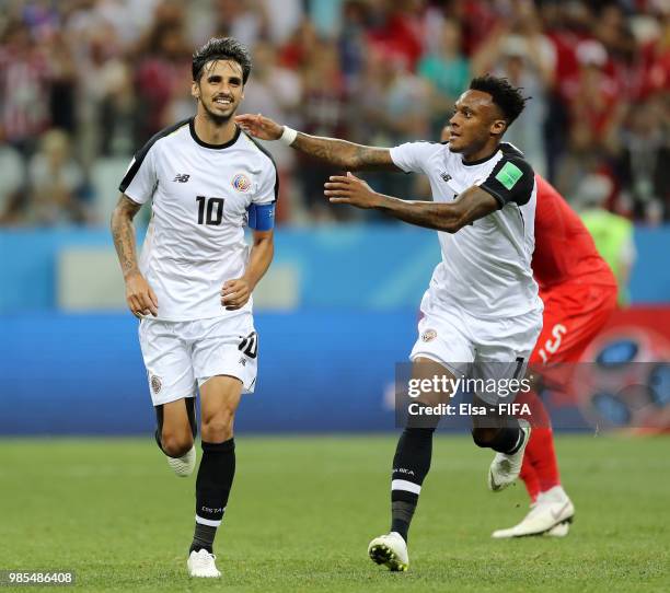 Bryan Ruiz of Costa Rica celebrates with teammate Rodney Wallace after scoring a penalty for his team's second goal during the 2018 FIFA World Cup...