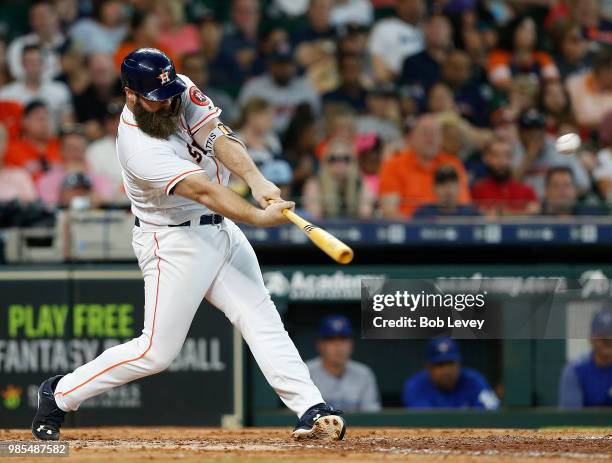 Evan Gattis of the Houston Astros doubles in a run in the fifth inning against the Toronto Blue Jays at Minute Maid Park on June 27, 2018 in Houston,...