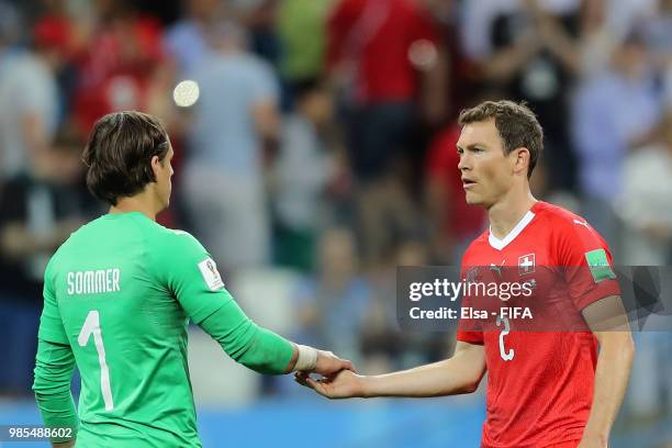 Yann Sommer of Switzerland shakes hands with Stephan Lichtsteiner of Switzerland after the 2018 FIFA World Cup Russia group E match between...