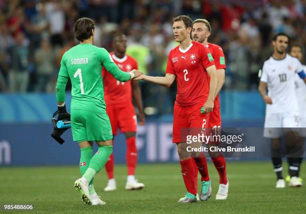 Yann Sommer of Switzerland shakes hands with Stephan Lichtsteiner of Switzerland after the 2018 FIFA World Cup Russia group E match between...