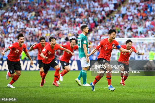 Heungmin Son of Korea Republic celebrates as Younggwon Kim of Korea Republic's is given after referee Mark Geiger consults VAR during the 2018 FIFA...