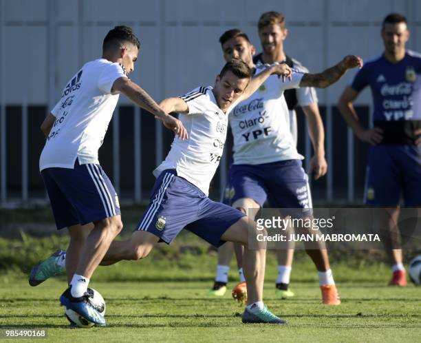 Argentina's midfielder Cristian Pavon vies with midfielder Giovani Lo Celso during a training session at the team's base camp in Bronnitsy, near...