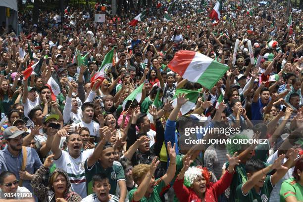 Football fans celebrate after Mexico passed through to the next round of the World Cup, after watching the match between Mexico and Sweden on a...