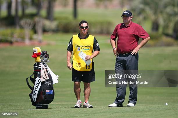 Jarrod Lyle looks on from alongside his caddie and his bag during the final round of the Chitimacha Louisiana Open at Le Triomphe Country Club on...