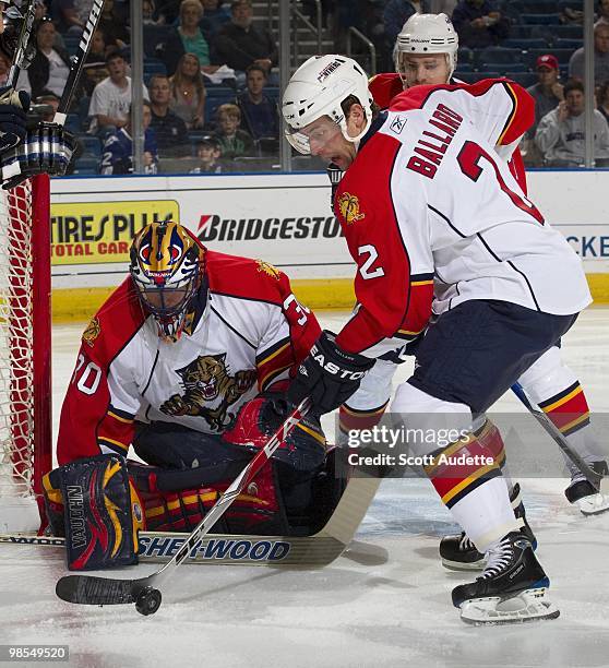 Keith Ballard of the Florida Panthers clears the puck in front of goaltender Scott Clemmensen during the first period against the Tampa Bay Lightning...