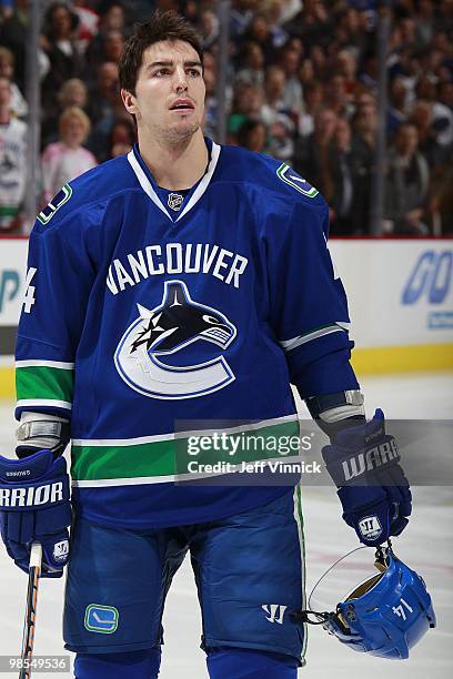 Alex Burrows of the Vancouver Canucks listens to the national anthems in Game Two of the Western Conference Quarterfinals against the Los Angeles...