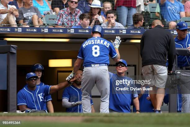 Mike Moustakas of the Kansas City Royals celebrates with teammates after hitting a home run in the seventh inning against the Milwaukee Brewers at...