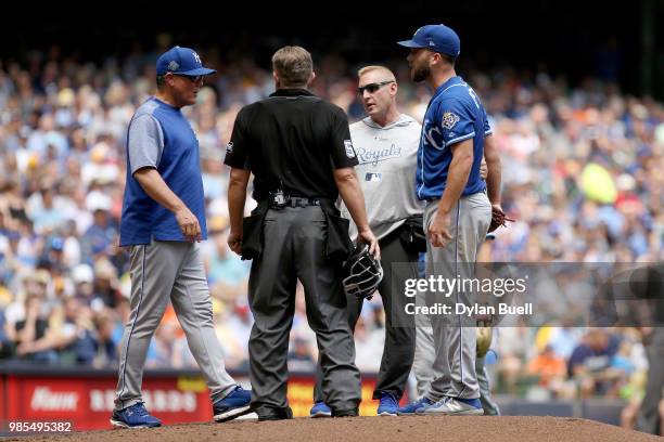 Manager Ned Yost of the Kansas City Royals meets with Danny Duffy in the sixth inning against the Milwaukee Brewers at Miller Park on June 27, 2018...