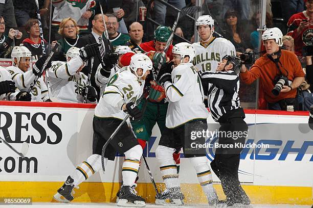 Derek Boogaard of the Minnesota Wild gets in a shoving match with Steve Ott and Toby Petersen of the Dallas Stars during the game at the Xcel Energy...