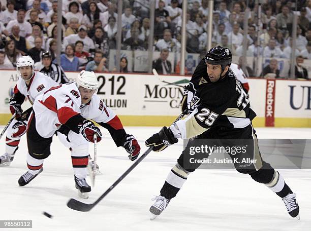 Maxime Talbot of the Pittsburgh Penguins takes a shot on goal in front of Nick Foligno of the Ottawa Senators in Game Two of the Eastern Conference...