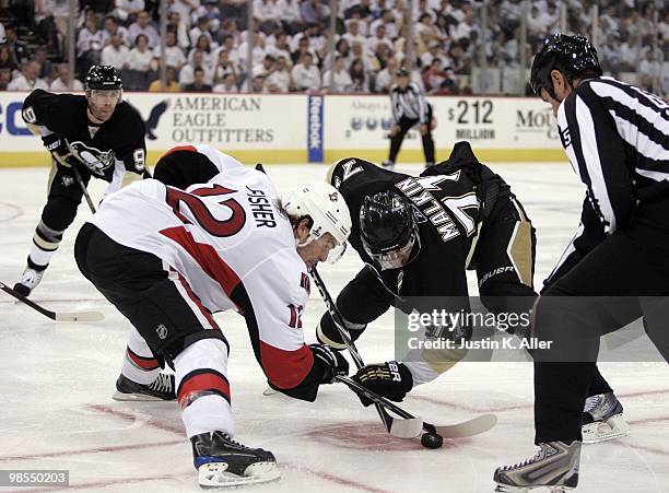 Mike Fisher of the Ottawa Senators takes a face-off against Evgeni Malkin of the Pittsburgh Penguins in Game Two of the Eastern Conference...