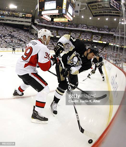 Mike Rupp of the Pittsburgh Penguins battles for the puck with Matt Carkner of the Ottawa Senators in Game Two of the Eastern Conference...