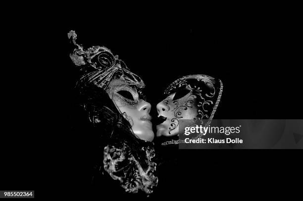 a kiss in the darkness... - theatermaske stock-fotos und bilder