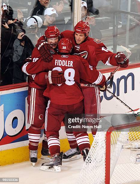 Shane Doan of the Phoenix Coyotes celebrates a goal against the Detroit Red Wings with teammates Taylor Pyatt and Vernon Fiddler in Game Two of the...