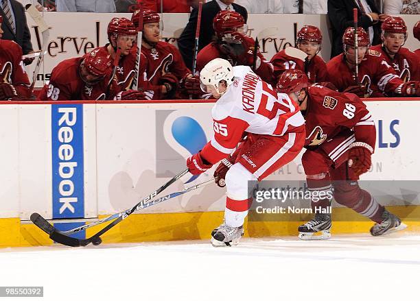 Niklas Kronwall of the Detroit Red Wings fights for the puck with Wojtek Wolski of the Phoenix Coyotes in Game Two of the Western Conference...