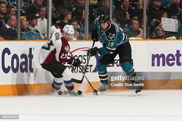 Milan Hejduk of the Colorado Avalanche and Joe Thornton of the San Jose Sharks battle for the puck in Game One of the Western Conference...