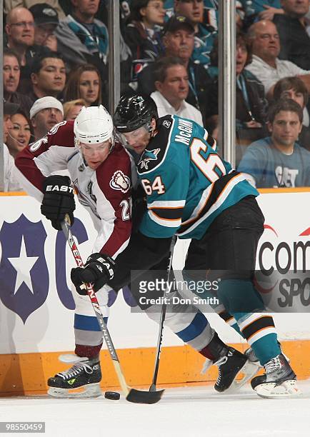 Paul Stastny of the Colorado Avalanche battles for the puck against Jamie McGinn of the San Jose Sharks in Game One of the Western Conference...