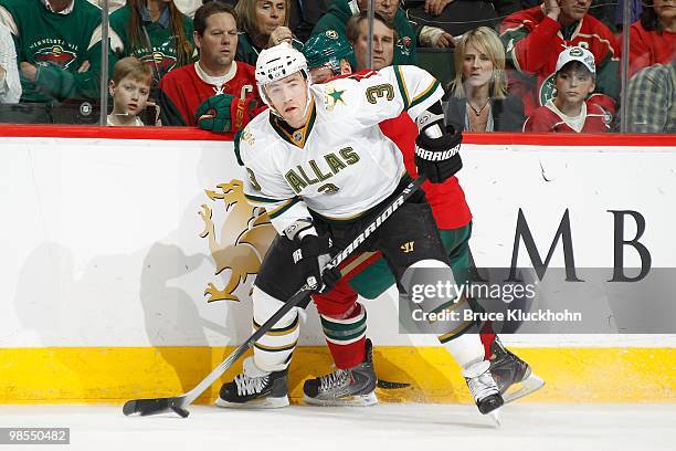 Stephane Robidas of the Dallas Stars uses his body to shield a member of the Minnesota Wild from the puck as he delivers a pass during the game at...