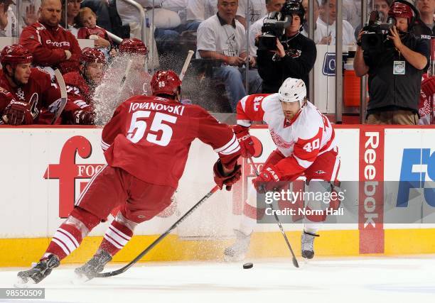 Henrik Zetterberg of the Detroit Red Wings puts on the breaks while passing the puck by Ed Jovanovski of the Phoenix Coyotes in Game Two of the...