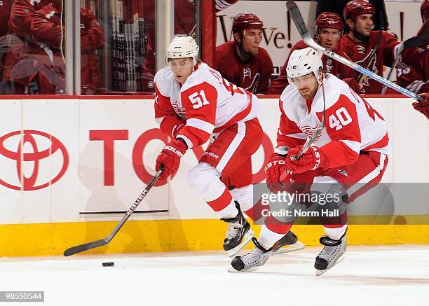 Valtteri Filppula of the Detroit Red Wings skates the puck up ice with teammate Henrik Zetterberg against the Phoenix Coyotes in Game Two of the...