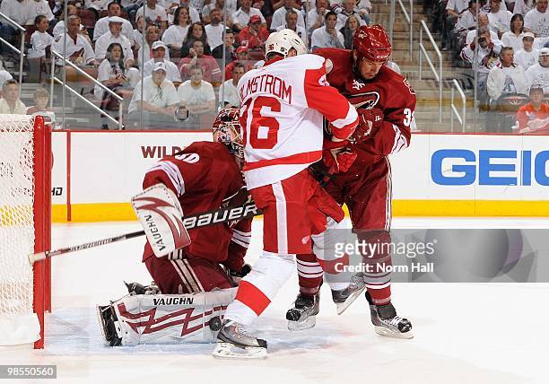 Goaltender Ilya Bryzgalov of the Phoenix Coyotes makes a pad save while teammate Ed Jovanovski fights for position in front of the net with Tomas...
