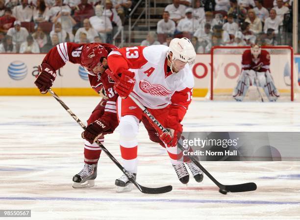 Pavel Datsyuk of the Detroit Red Wings skates with the puck while fighting off Vernon Fiddler of the Phoenix Coyotes in Game Two of the Western...
