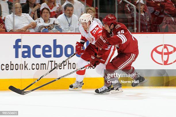 Niklas Kronwall of the Detroit Red Wings and Ed Jovanovski of the Phoenix Coyotes fight for possession of the puck in Game Two of the Western...